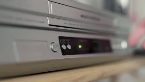 Close up of a hand puting a videotape into video player. Retro vhs cassete. Stock Footage 305182632
