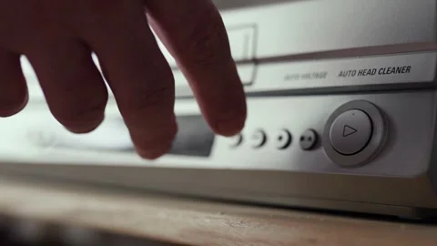 Close up of a hand puting a videotape into video player. Retro vhs cassete. Stock Footage 305182633