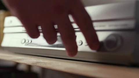 Close up of a hand puting a videotape into video player. Retro vhs cassete. Stock Footage 305182800