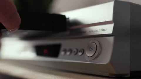 Close up of a hand puting a videotape into video player. Retro vhs cassete. Stock Footage 305183337