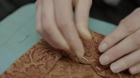 Close up hand puts needle into fabric close up Stock Footage 263356089