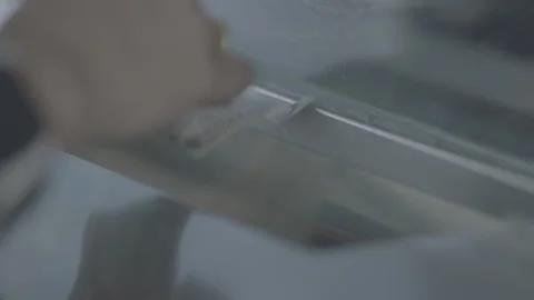 Close Up Hand Putting Cash Through Window Slot At Movie Theater Box Office Stock Footage 134722550