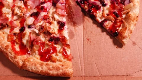 Close-up of hand putting a half-eaten pizza slice back into the delivery box 動画素材 123659751