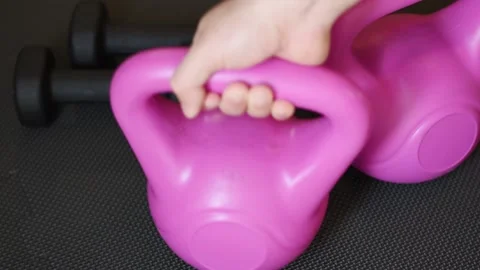 Close up hand putting a kettlebell in black fitness zone Stock Footage 237729223