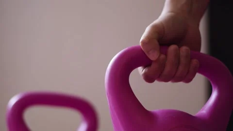 Close up hand putting a kettlebell on the floo Stock Footage 237729258
