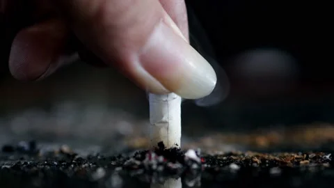 Close up Hand putting out a cigarette Stock Footage 145972199