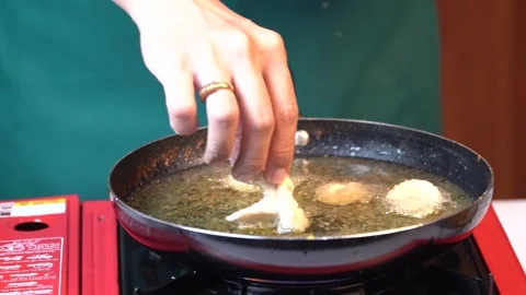 Close Up of Hand Putting Raw Shrimp Meat Balls into Frying Pan 스톡 동영상 334322488