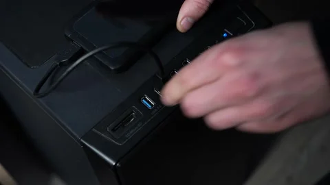 Close up of hand putting USB cable of external hard disk into computer Video stock 166002485