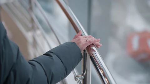 Close-up Hand on Rail with Ring and Glass Reflection in Urban Setting Video stock 304974105