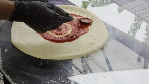 A close-up of a hand on a raw pizza dough. Stock Footage 323866550