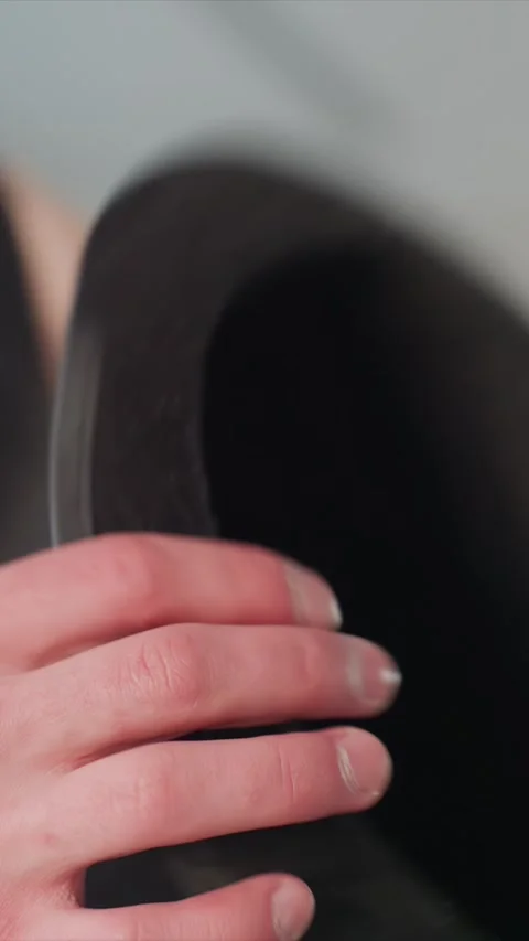 Close up of hand reaching for and grasping black top hat then brown magic cap Stock Footage 344412886