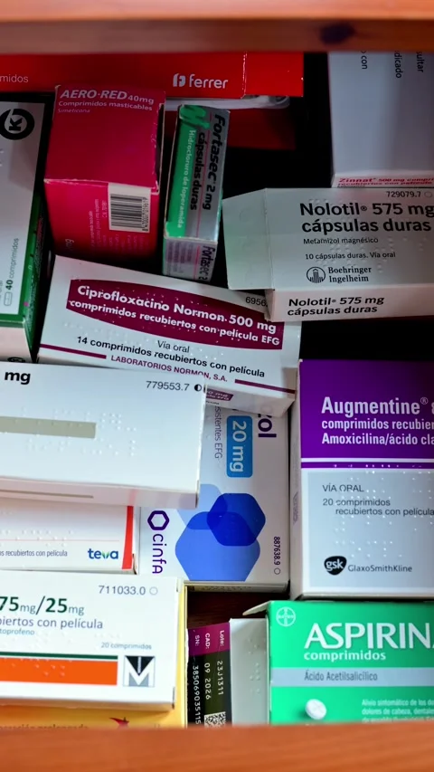 Close Up Of Hand Reaching For Medication From A Shelf Of Pharmaceutical Boxes Stock Footage 325418158