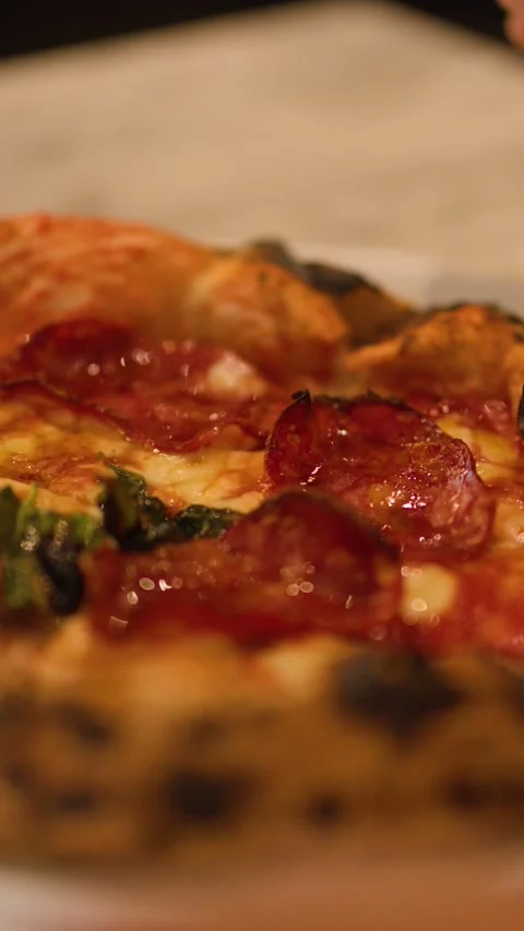 Close Up of Hand Reaching for Pepperoni Pizza on Marble Table Stock Footage 337519509