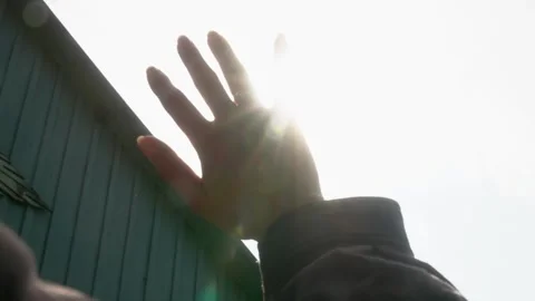 Close-up Hand Reaching Toward Sunlight With Bright Outdoor Backlight Stock Footage 346799255