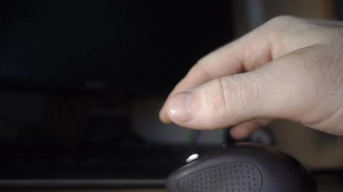 Close-Up of a Hand Reaching Towards a Computer Mouse in a Dark Room Stock Footage 341402536