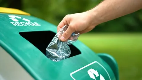 Close-Up of Hand Recycling a Bottle in bin. Stock Footage 316279488