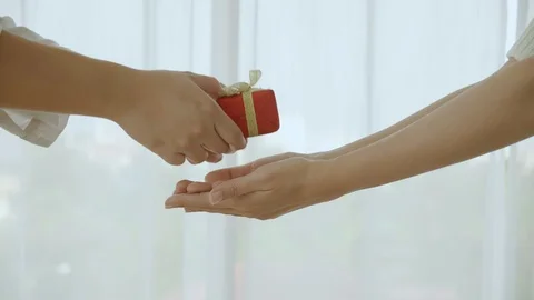 Close up of the hand is red gift box, golden bow Stock Footage 121459400