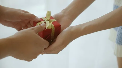 Close up of the hand is red gift box, golden bow Stock Footage 121459469