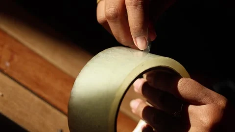 Close up hand removing white adhesive tape Stock Footage 329478021