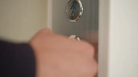 Close up of hand repeatedly interacting with elevator floor button panel Stock Footage 346652802