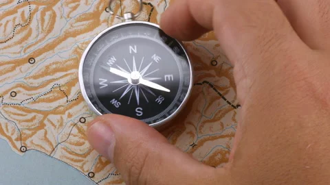 Close up hand rotating compass on blank map Stock Footage 140742256