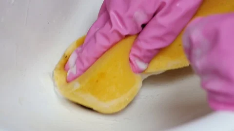 Close up of a hand in rubber glows cleaning a bathroom sink Stock Footage 72787148