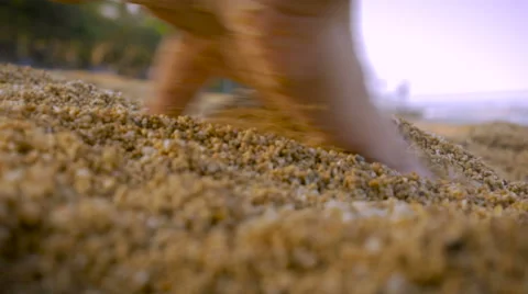 Close up of a hand running fingers through course sand on the beach Stock Footage 58122554