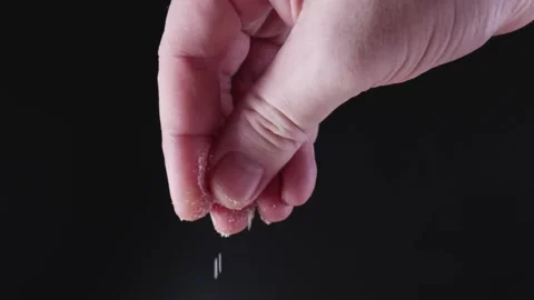 Close-up hand salt the dish covered with motion Stock Footage 155899533