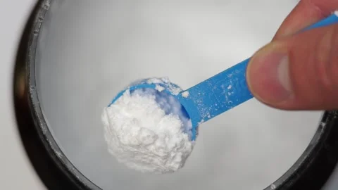 Close up of a hand scooping creatine with a scoop Stock Footage 311755891