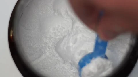Close up of a hand scooping creatine with a scoop Stock Footage 311755974