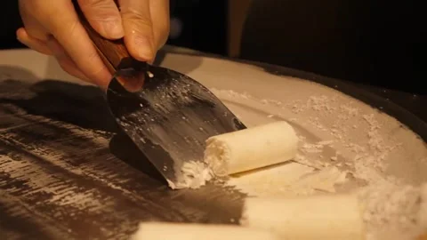 Close-Up of Hand Scraping Rolled Ice Cream on Cold Plate Stock-Footage 345293011