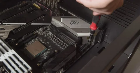 Close up of hand screwing motherboard into computer frame. Stock Footage 152357687