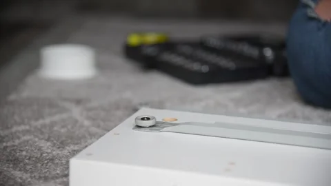 Close up hand screwing with screwdriver. Assembling DIY furniture at home. Stock Footage 132591646