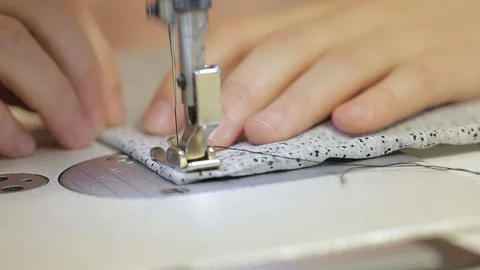 Close-up of a hand scribbling cloth on a sewing machine. Stock Footage 90129162
