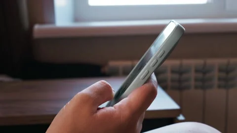 Close-Up of Hand Scrolling on Smartphone with Coffee in Background Stock Footage 339180830