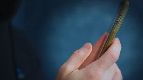 Close-Up of Hand Scrolling on Smartphone – Phone Addiction Concept Stock Footage 328075851