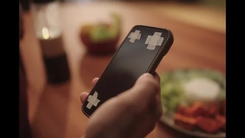 Close up of hand scrolling on smartphone with tracking markers Stockbeeldmateriaal 327072890