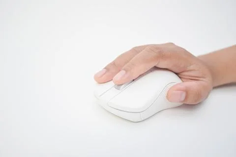 Close-up of a hand scrolling a white wireless computer mouse on a white bac.. Stock Photos