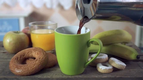 Close up of a hand serving coffee in a green ceramic mug Stock Footage 102105909
