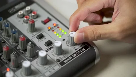 Close-up hand setting up the audio mixing console, controller or board audio mix Stock Footage 156065354