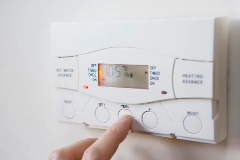 Close up of hand  setting control for heating and hot water Stock Photos