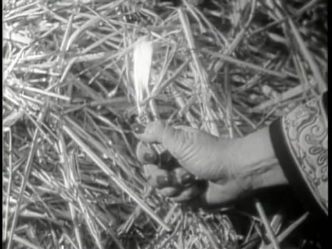 Close-up of hand setting hay on fire with lighter Stock Footage 260251052