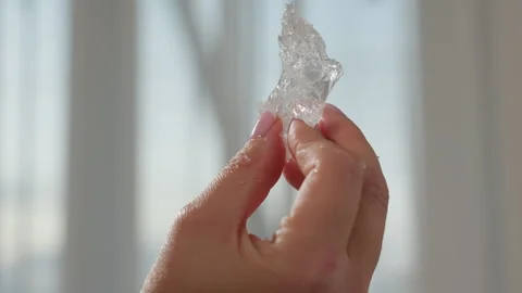 Close Up of Hand Shaking Transparent Soluble Material with Shadow on Wall Video stock 307986092