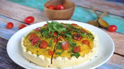 Close up of a hand showing a piece of delicious quiche. Видео 137028364