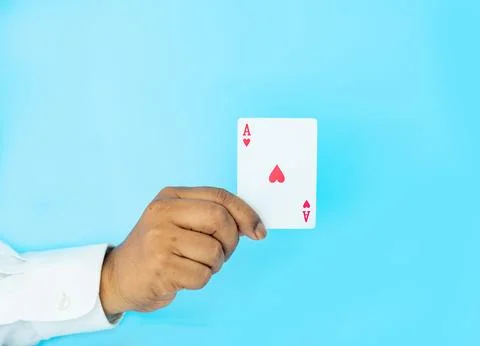 Close up hand shown a red Ace playing card on aqua background, Stock Photos