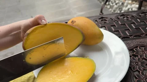 Close Up of a hand sliced Mango fruit cubes with knife, Tropical fruit. How to Stock Footage 306308356