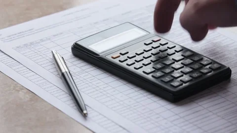 Close-up of a hand slowly counting on a calculator Stock Footage 85433726