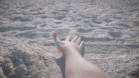 Close-up hand slowly passes through the sand Stock Footage 96079702