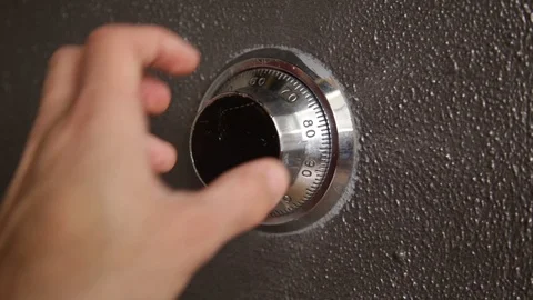 Close Up on a hand slowly turning a safe combination lock Stock Footage 86894606