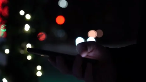 Close-up Hand with Smartphone on the Background of City Lights at Night Stock Footage 148098093